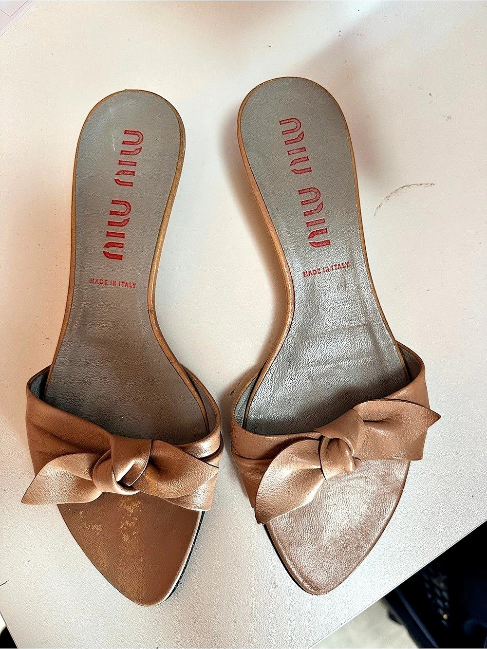 Miu Bow Mules in warm taupe